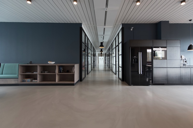 A bright, modern open-plan workspace with glass-walled rooms